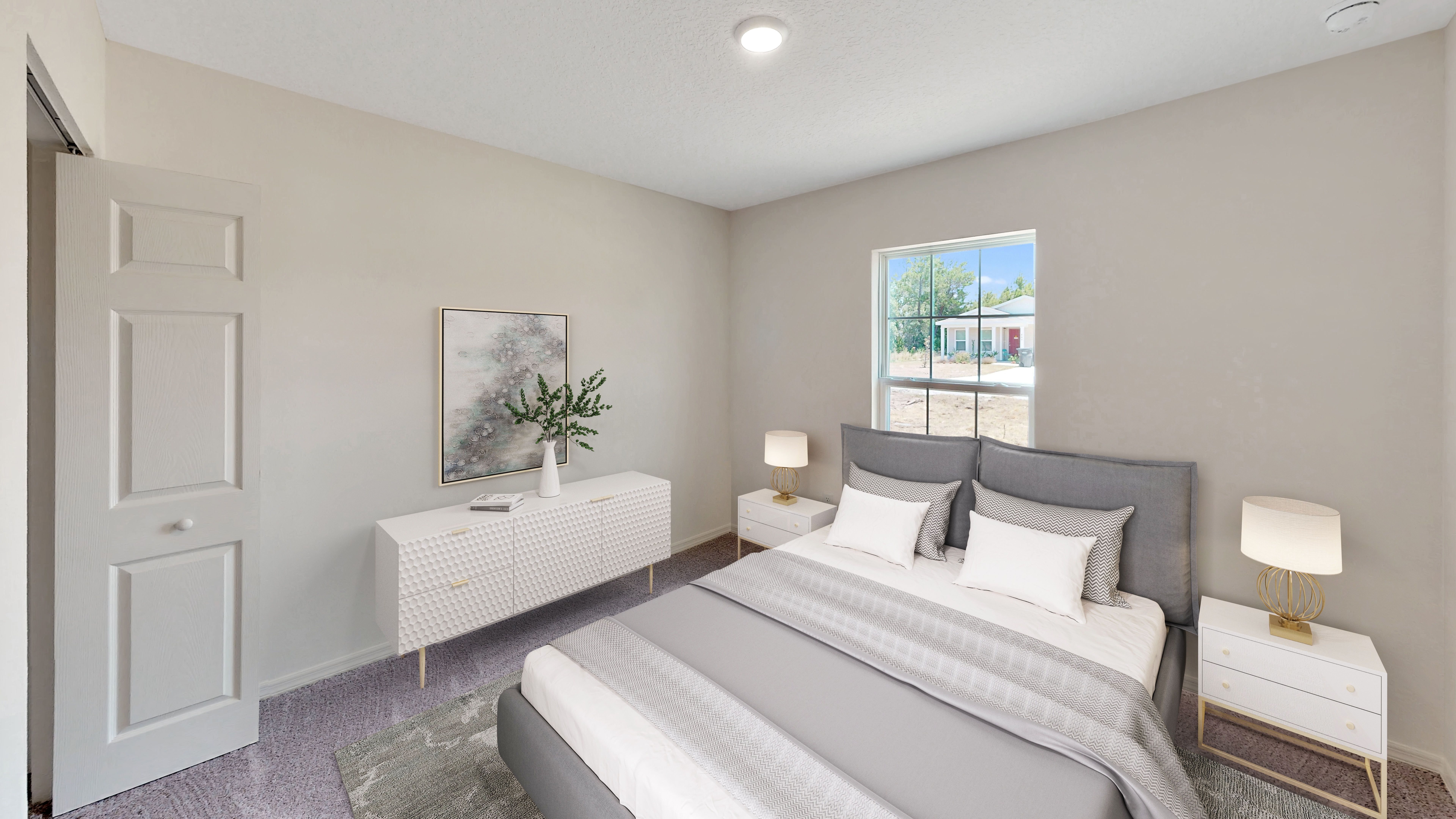 Modern bedroom interior with a gray upholstered bed, white side tables, and dresser, featuring a decorative plant and wall art near a bright window.