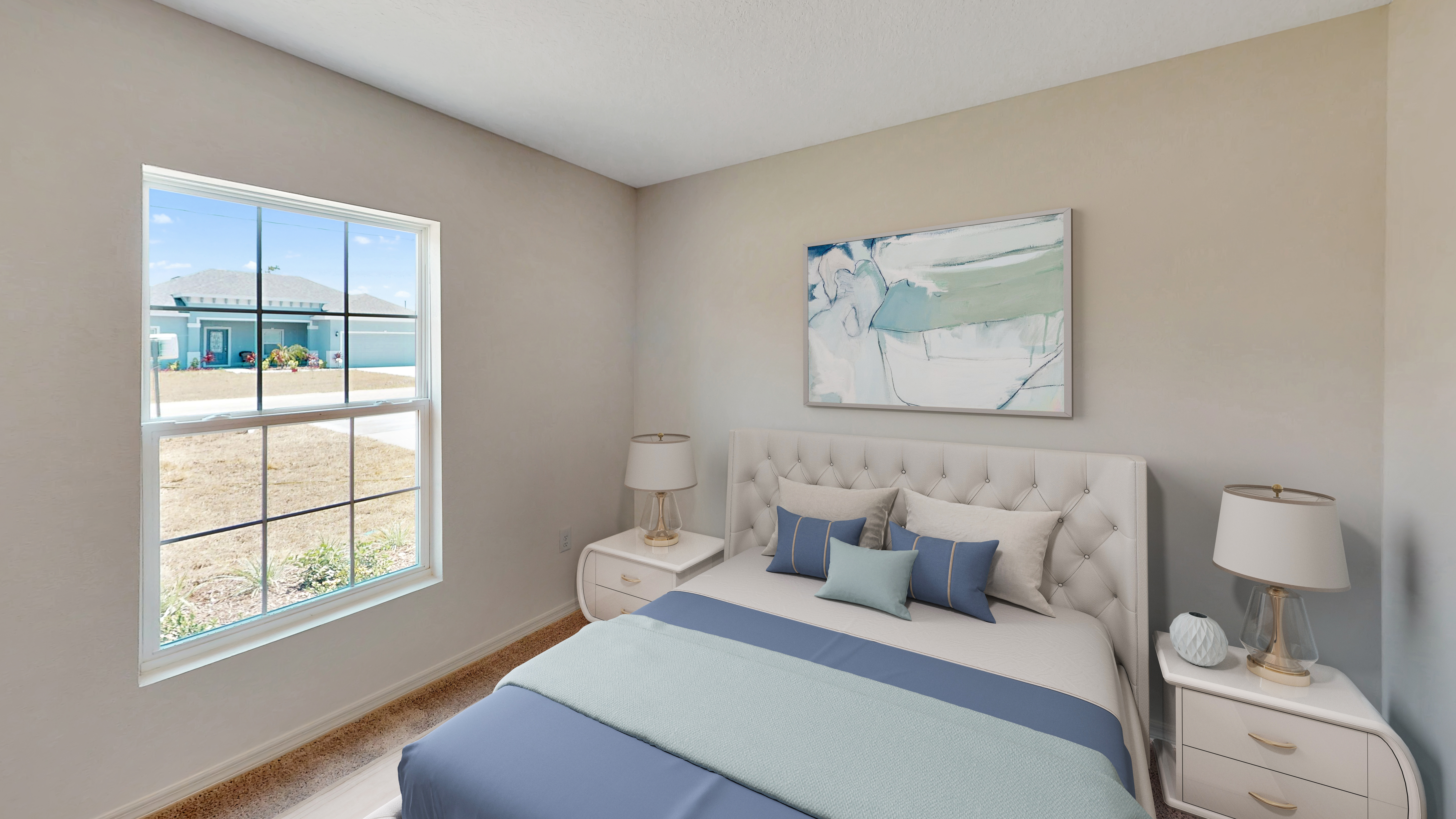 "Bright bedroom featuring a plush tufted bed with blue and gray bedding, matching nightstands with lamps, and a large window with a view of the neighborhood."