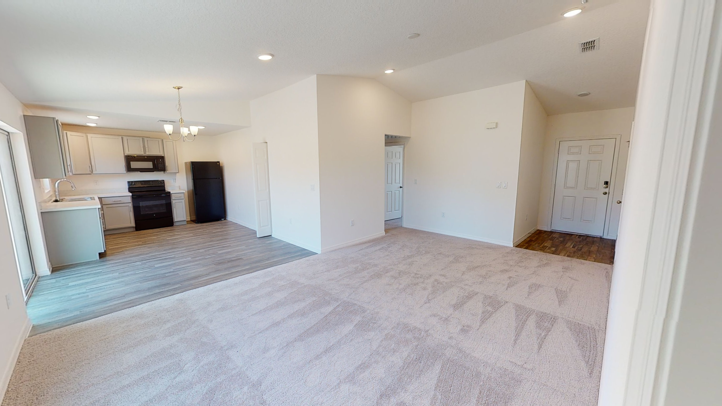 Spacious open-plan kitchen and living area with modern appliances and natural light.