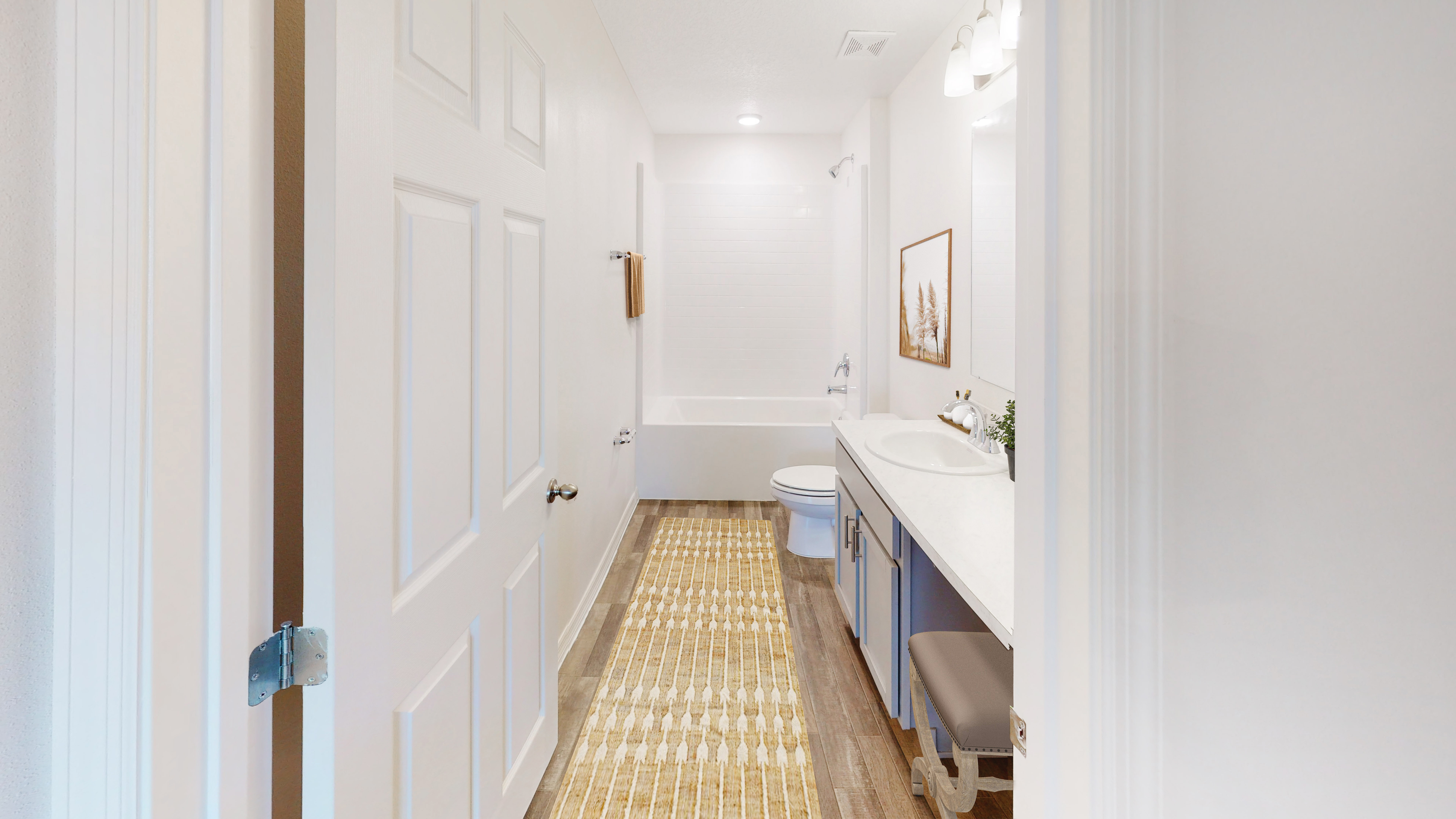 Modern bathroom with white walls, a bathtub, wooden floor, and a long rug for a cozy feel.