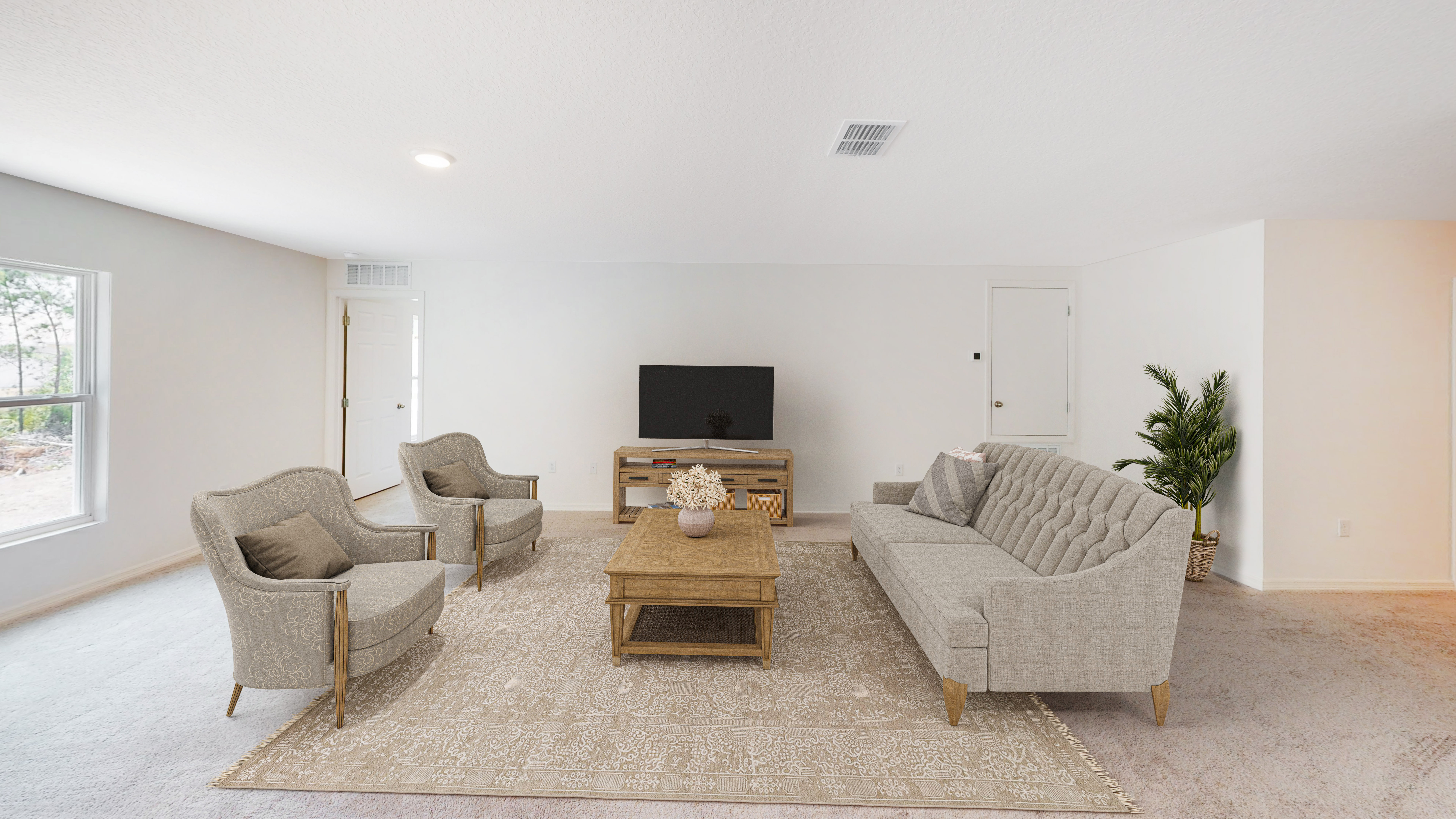 Spacious, modern living room with gray furniture, a large TV, and elegant decor on a patterned rug.